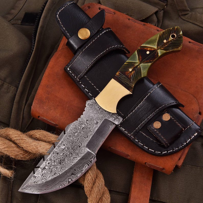 Tracker knife with full tang steel blade, durable handle, and leather sheath for outdoor survival
