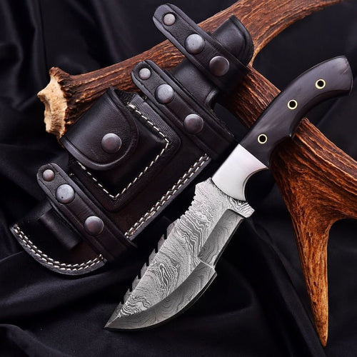 Tracker knife with full tang steel blade, durable handle, and leather sheath for outdoor survival
