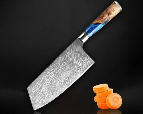 Decorative chef's knife with a wooden handle next to sliced carrots on a black background