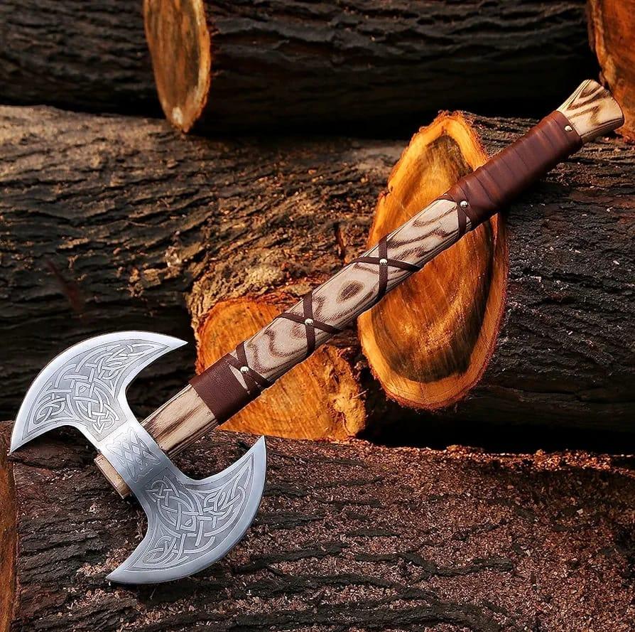 A double-headed axe with a silver blade and brown wooden handle, placed against a background of cut wood.