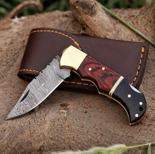 Damascus folding knife with patterned steel blade, ergonomic handle, and secure locking mechanism by Viking Hills
