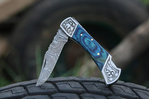 Damascus folding knife with patterned steel blade, ergonomic handle, and secure locking mechanism by Viking Hills
