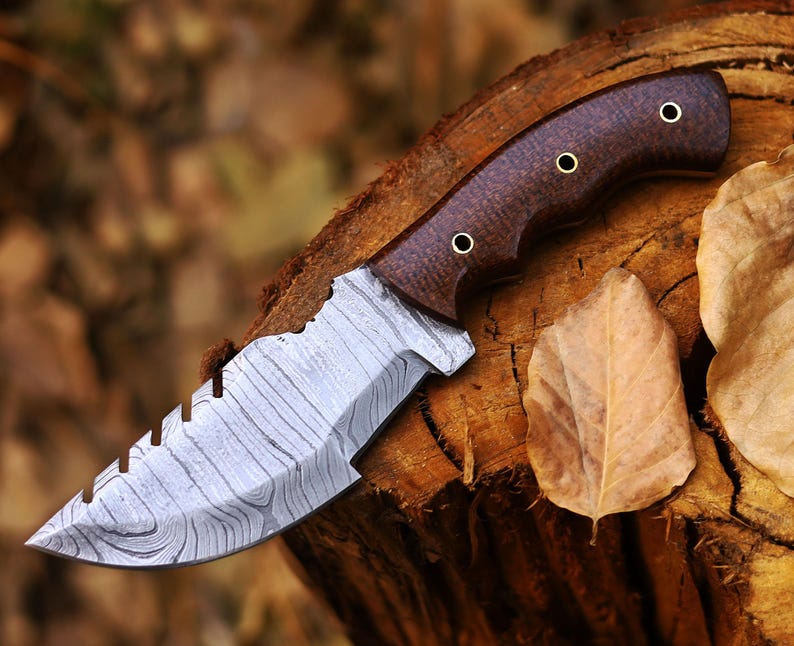 Tracker knife with full tang steel blade, durable handle, and leather sheath for outdoor survival
