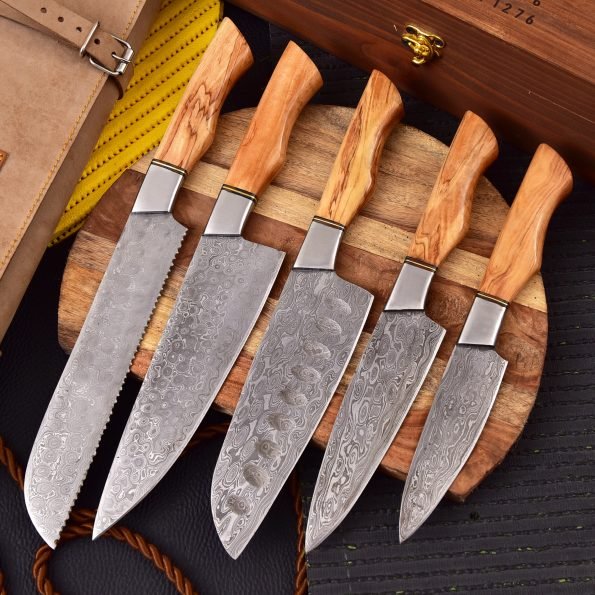 Set of six Damascus steel knives with wooden handles on a wooden block.
