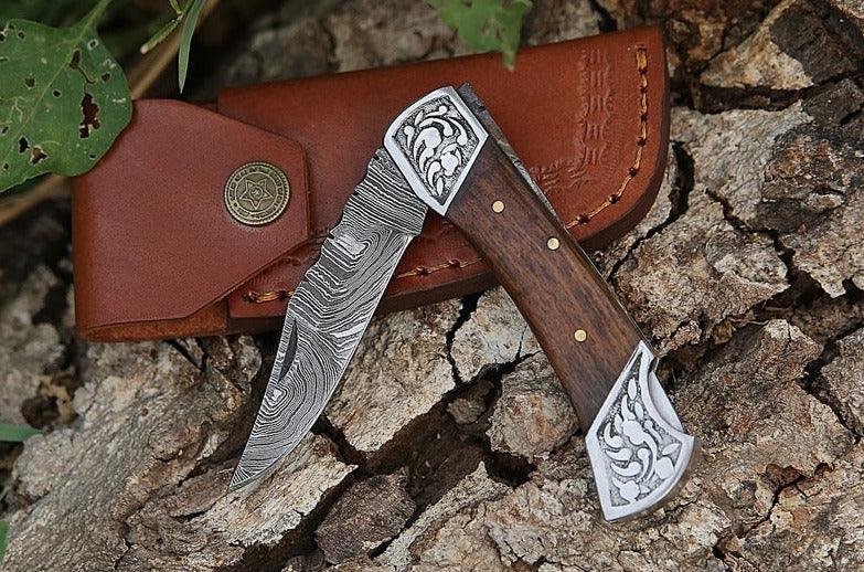 Damascus folding knife with patterned steel blade, ergonomic handle, and secure locking mechanism by Viking Hills
