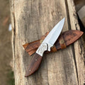 Handmade skinner knife with sharp curved steel blade and ergonomic handle for hunting and skinning tasks
