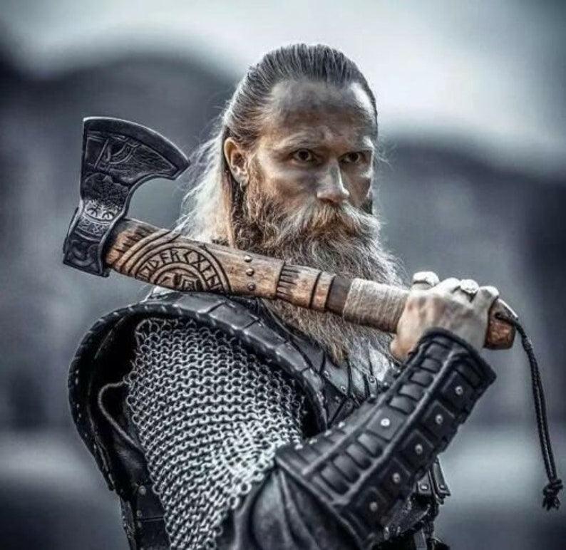 A Viking axe with a wooden handle and a steel head, holding it with a dramatic pose against a dark background.