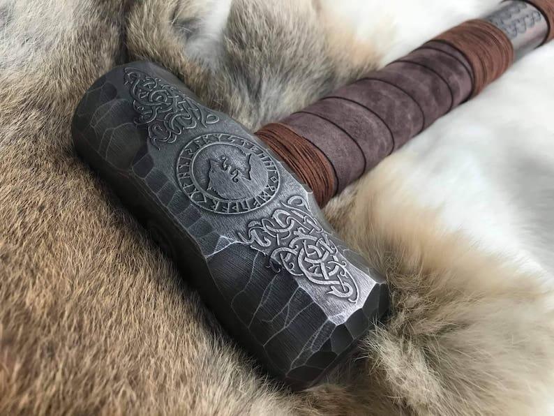 Viking engraved hammer with detailed Norse carvings, handcrafted metal head and wooden handle for decor and cosplay
