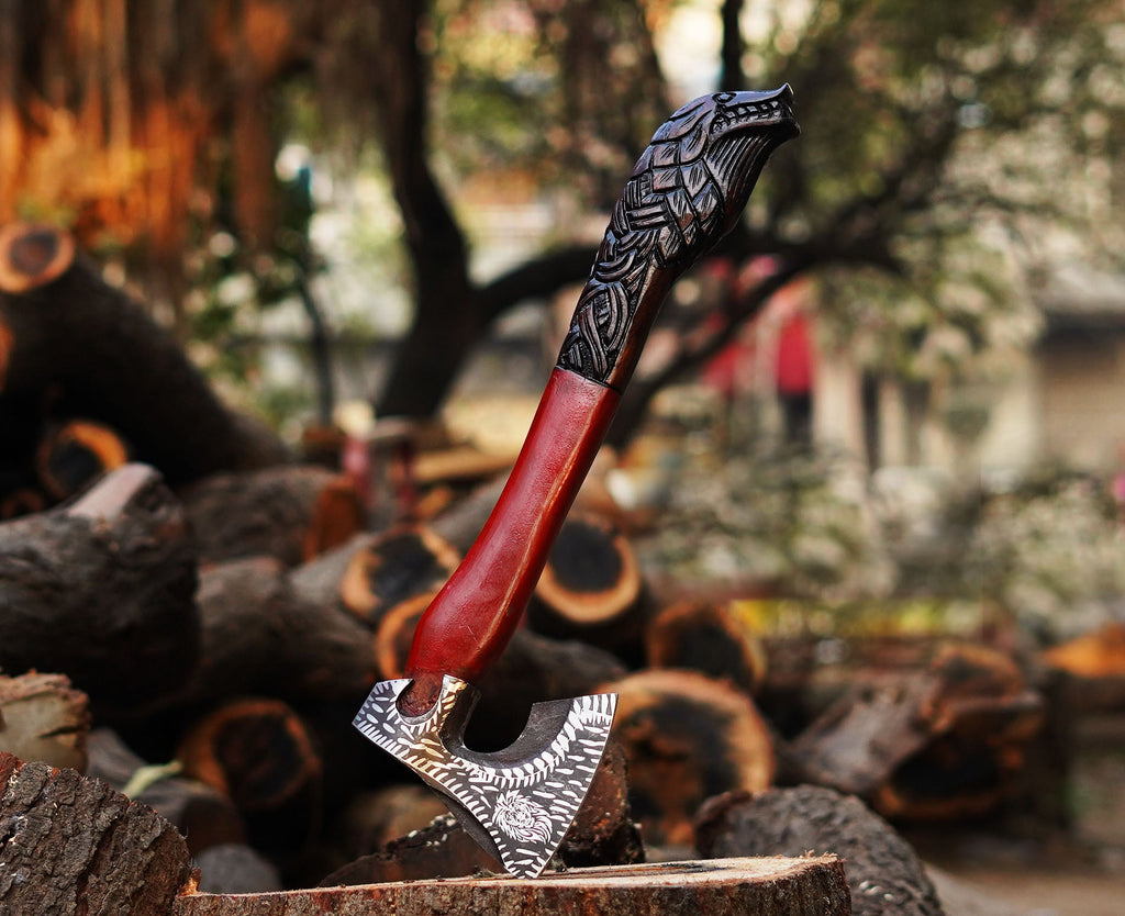 A handcrafted axe with a Corban steel blade and an Ash wood handle, featuring intricate engravings on the handle.