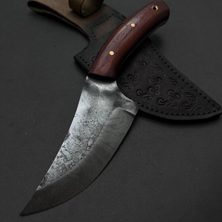Handmade skinner knife with sharp curved steel blade and ergonomic handle for hunting and skinning tasks
