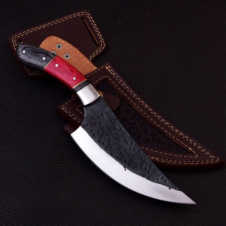 Handmade skinner knife with sharp curved steel blade and ergonomic handle for hunting and skinning tasks
