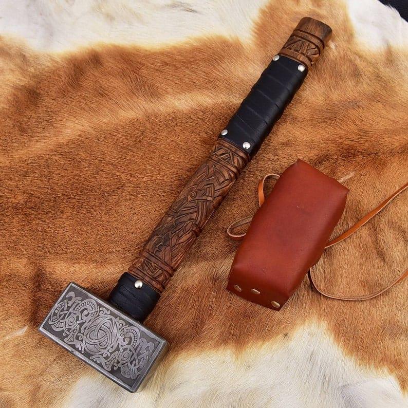 Viking engraved hammer with detailed Norse carvings, handcrafted metal head and wooden handle for decor and cosplay
