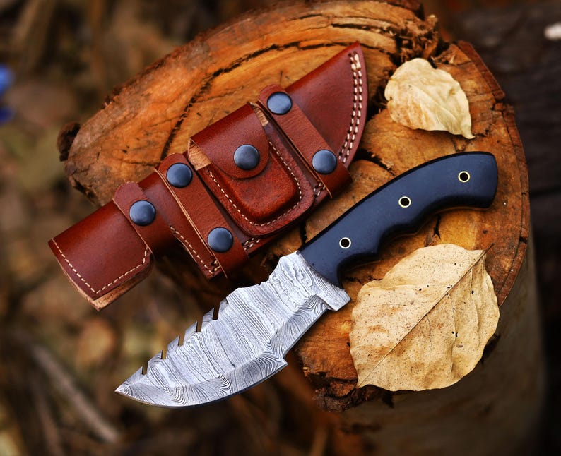 Tracker knife with full tang steel blade, durable handle, and leather sheath for outdoor survival

