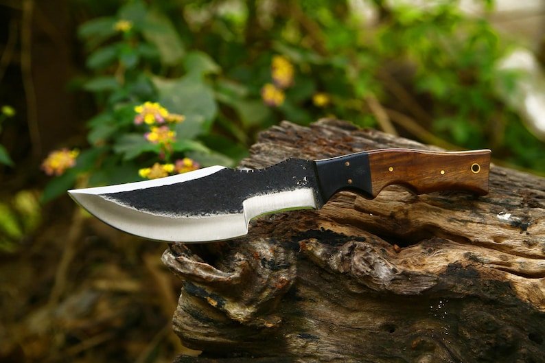 Tracker knife with full tang steel blade, durable handle, and leather sheath for outdoor survival
