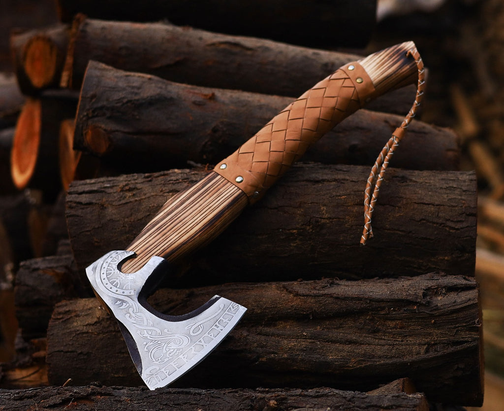 A personalized Viking axe with a wooden handle and a leather cover, featuring a patterned steel head.